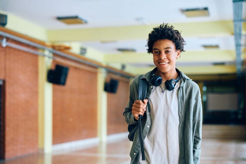 happy-black-teenage-boy-in-school-hallway-looking-2024-12-13-21-13-52-utc (1)