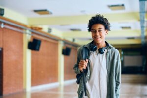 happy-black-teenage-boy-in-school-hallway-looking-2024-12-13-21-13-52-utc (1)
