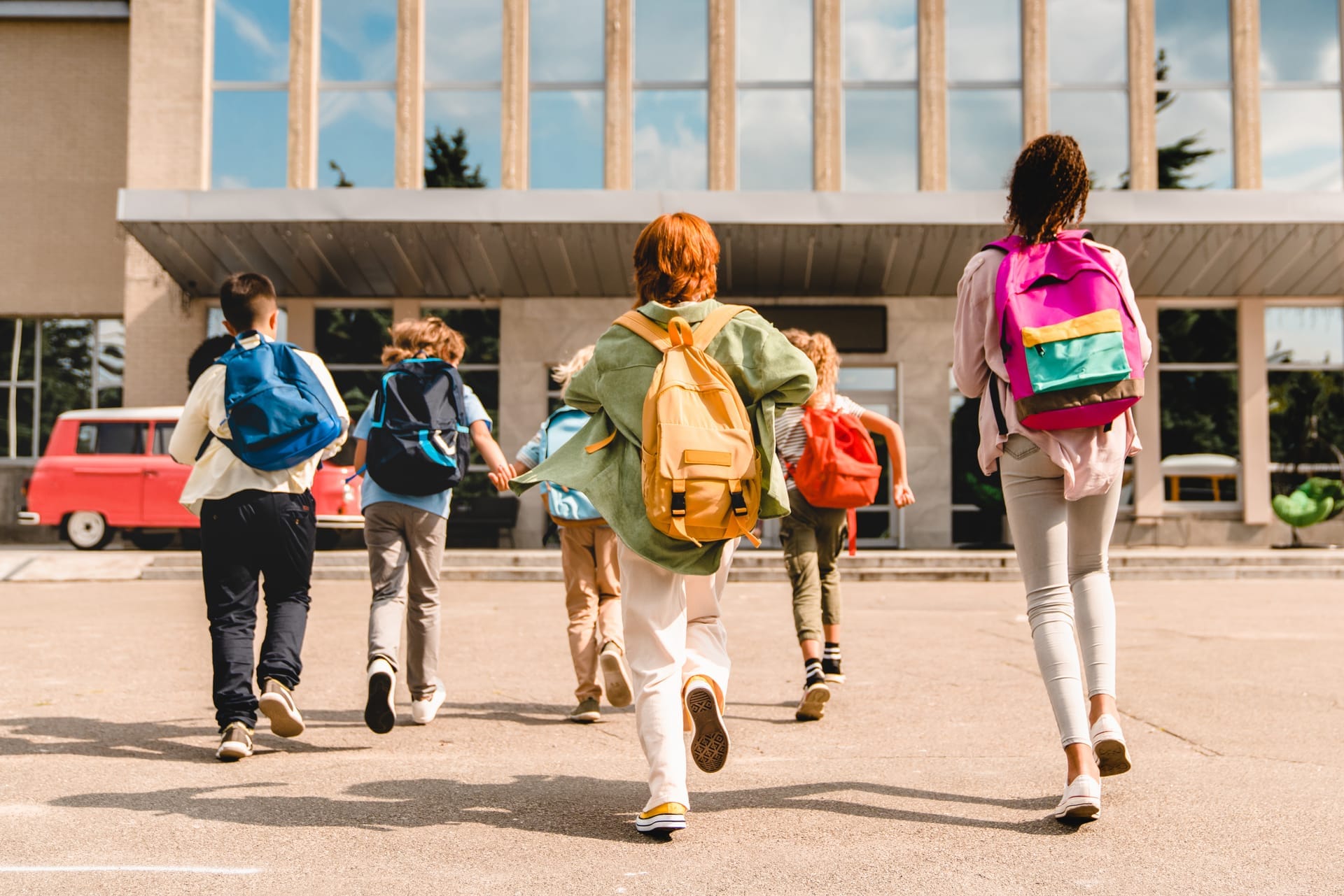 children with backpacks run towards school buildin 2026 09 23 03 50 19 utc (1)