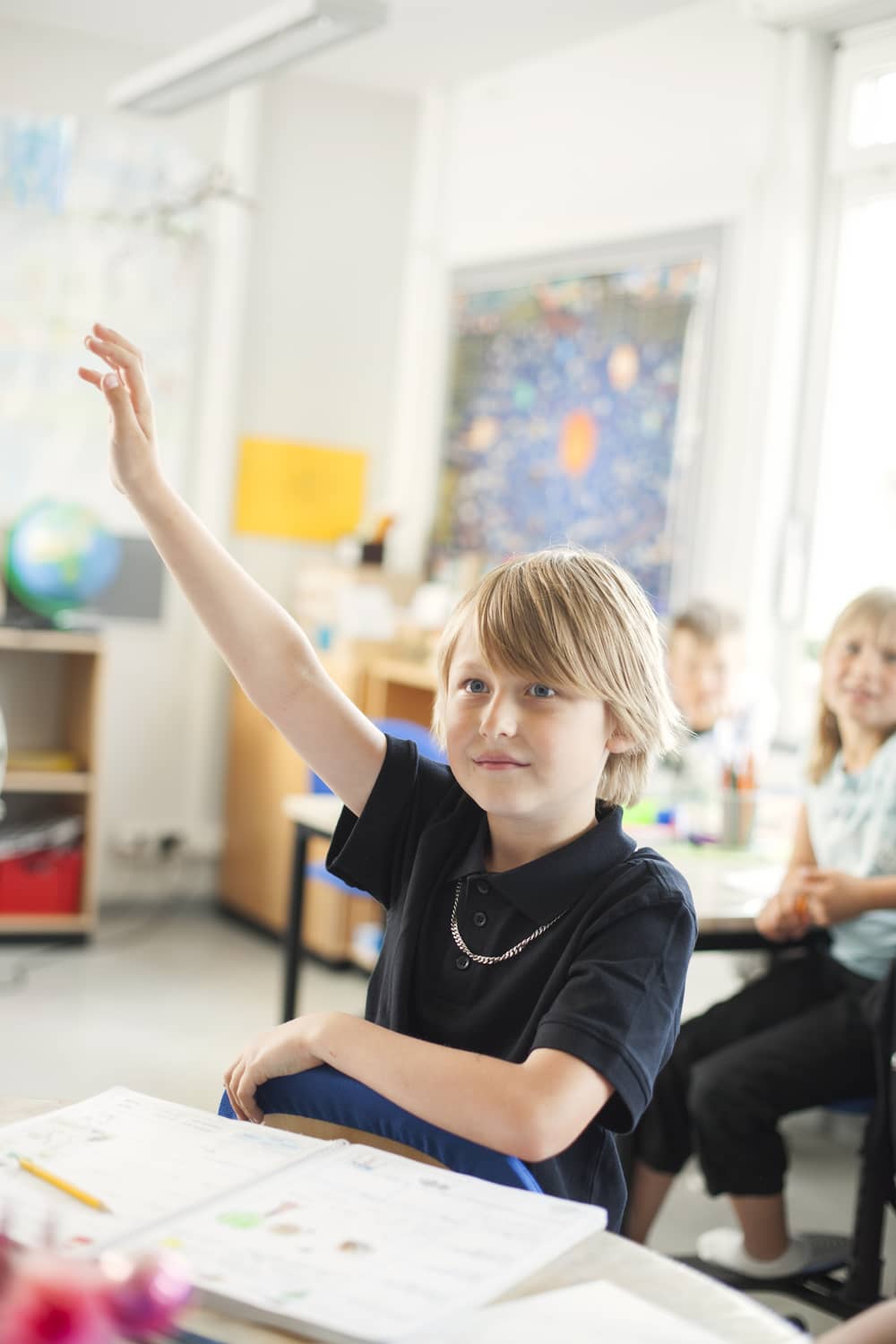 schoolboy raising hand in classroom 2024 10 18 04 05 47 utc (1)