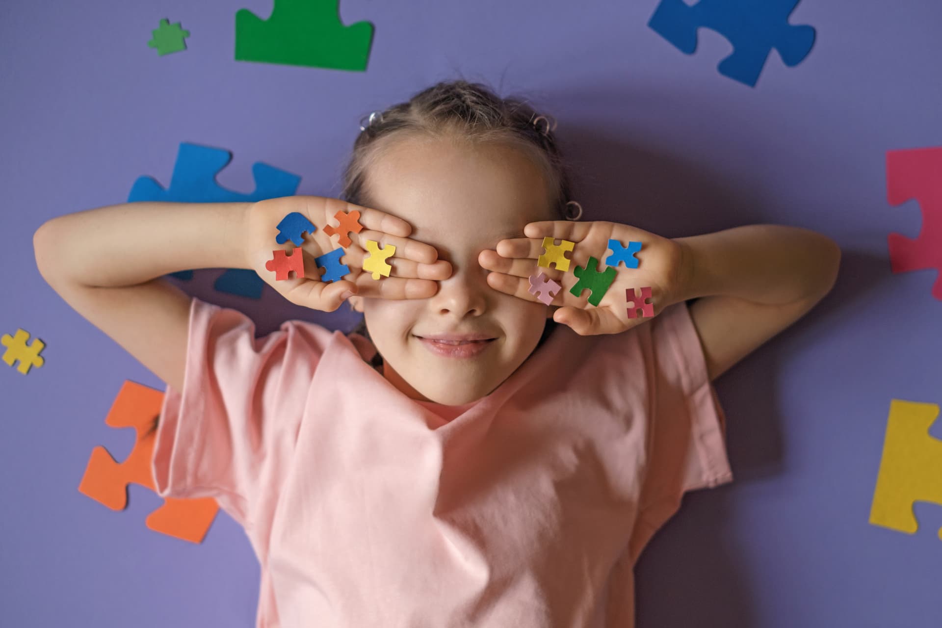 smiling girl playing with colorful puzzle pieces 2026 01 09 11 53 39 utc (1)