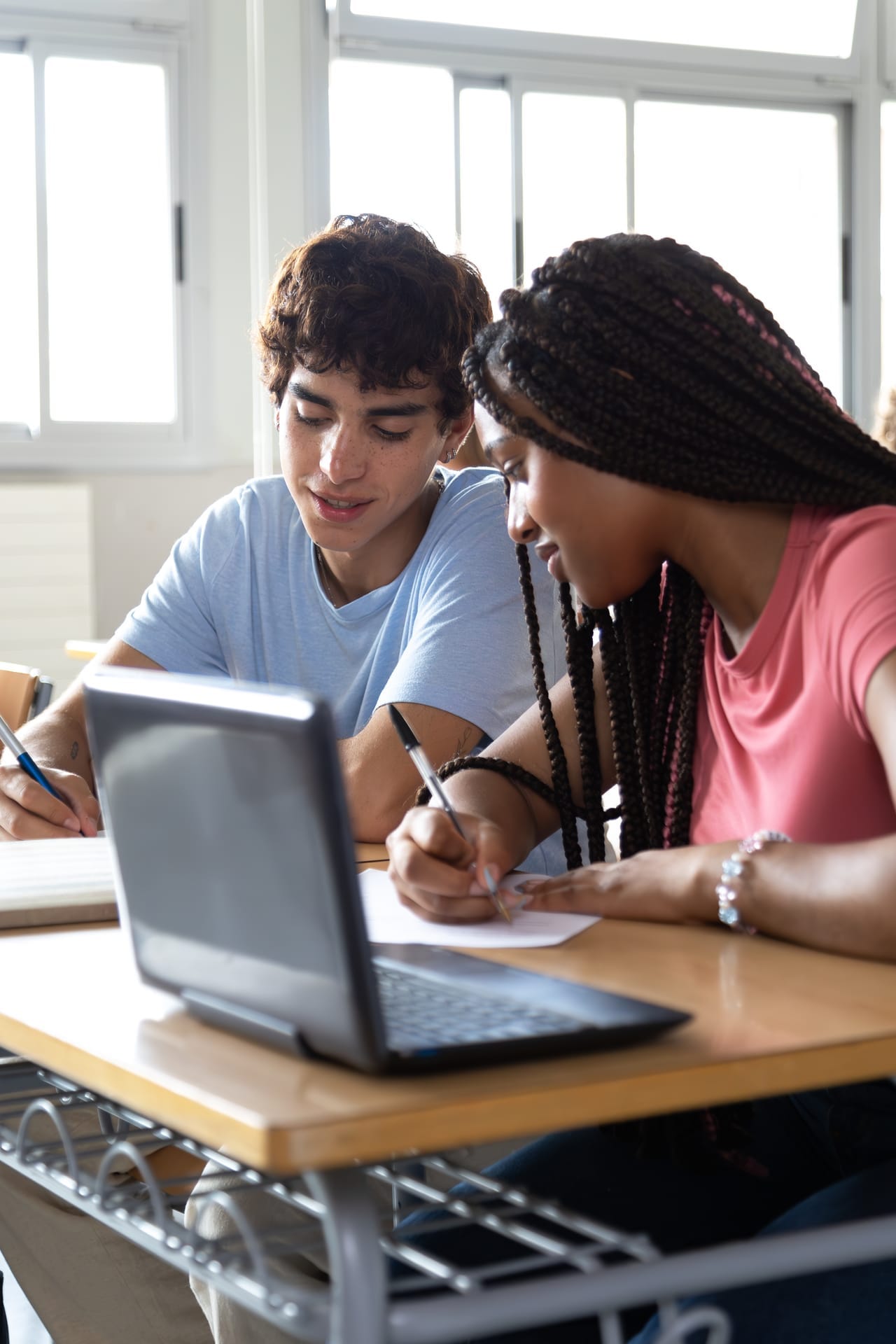 High school students talking together in a classroom
