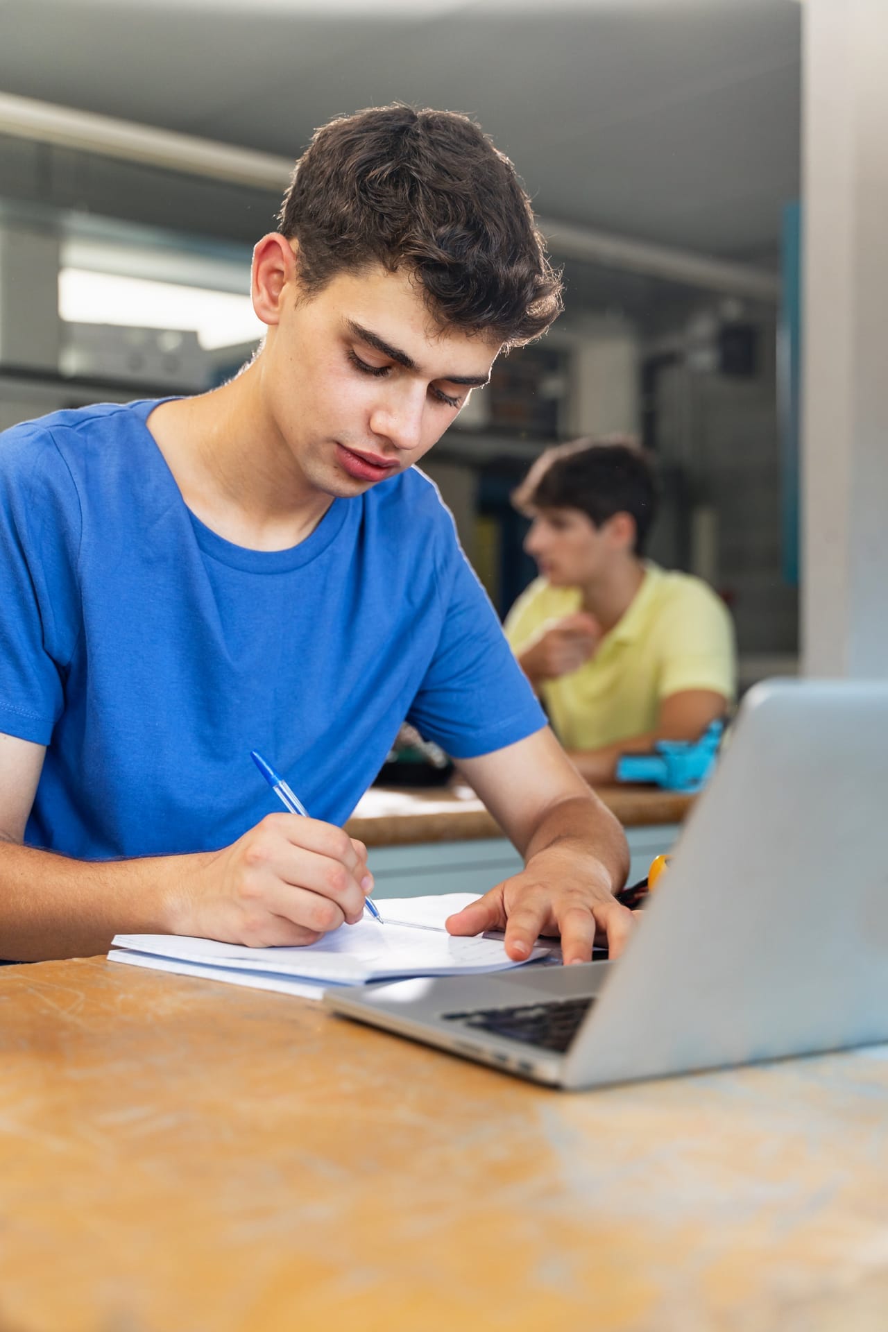 High school student organizing assignments in a notebook