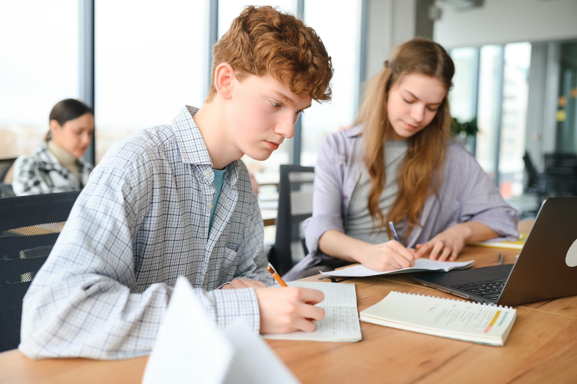 High school students working together on laptops