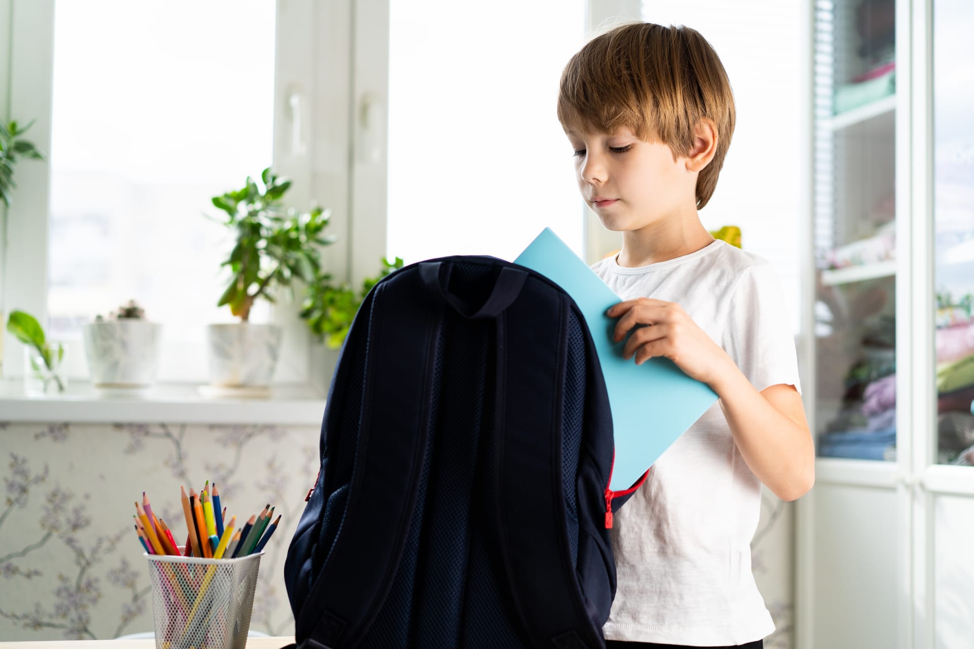 the schoolboy collects books in a backpack 2024 10 21 02 03 02 utc (1)