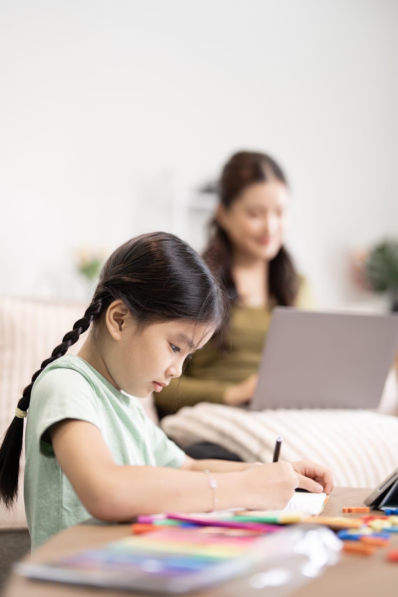 young girl drawing while woman works on laptop at 2026 06 03 19 44 17 utc (1)